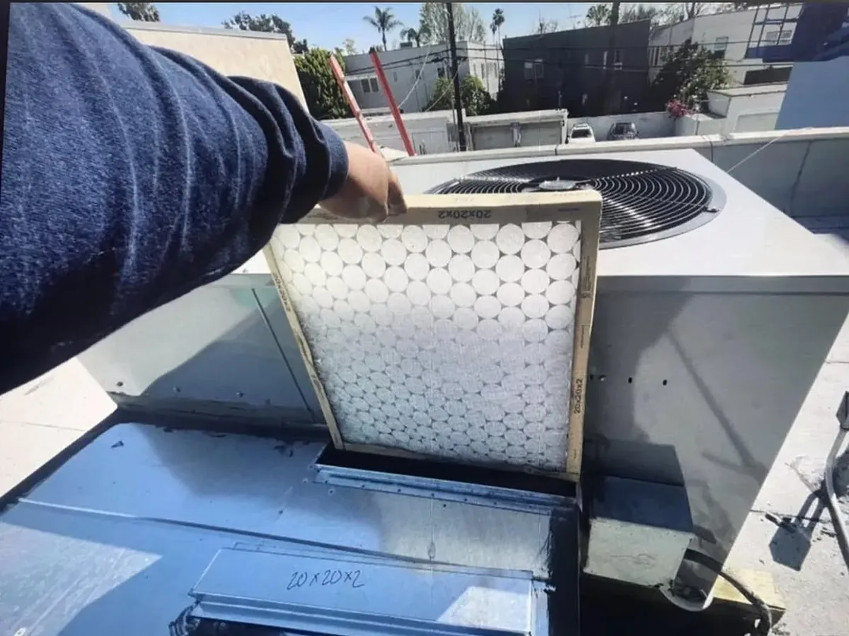 Nice And Cool technician performing HVAC maintenance with a clean filter